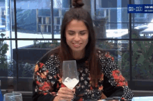 a woman sitting at a table with a glass of wine and a sign that says ch-duc