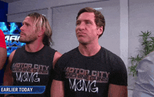 two men wearing black motor city machine guns shirts