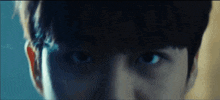 a close up of a person 's face with a dark background