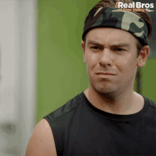 a man wearing a headband with the real bros of sind valley on it
