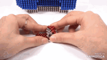 a person is playing with magnetic beads made by the magnetic man