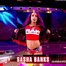 a woman with purple hair wearing a raw shirt and shorts