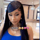 a woman with long black hair and a necklace is wearing a blue tank top and earrings .