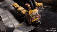 a sandwich is being made on a grill with the words made in animotica on the bottom right