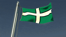 a green white and black flag with a cross on it