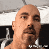 a bald man with a beard and a magic hour logo on the bottom right