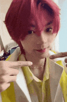 a person with red hair is wearing a yellow shirt and a white jacket