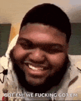 a man with a beard is smiling and saying " got em "