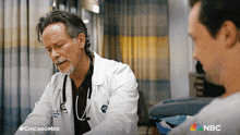 a doctor is talking to a patient with the hashtag #chicagomed at the bottom