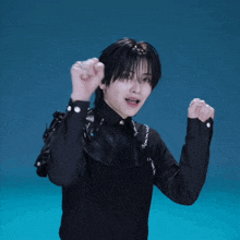 a man in a black shirt with chains around his neck is making a funny face