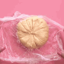 a close up of a person 's hand holding a piece of dough with the words mr.cakes written on the bottom
