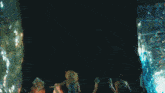 a group of people standing in front of a fire with the words aespagifs in the corner