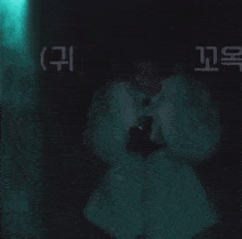 a person in a white jacket covering their ears with their hands in a dark room