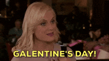 a woman is sitting at a table in a restaurant holding a cell phone and saying `` galentine 's day ! ''