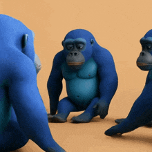 a group of blue monkeys are standing and sitting on the ground