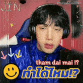 a young man wearing headphones with a smiley face and the words tham dai mai
