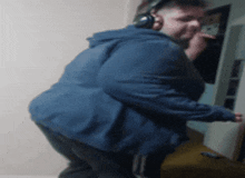 a man wearing headphones and a blue jacket