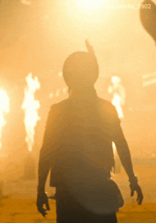 a silhouette of a person standing in front of a fire with the hashtag avantika_0902
