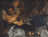 a person is sitting in front of a fire with a clock hanging from the ceiling that says ' a & b '