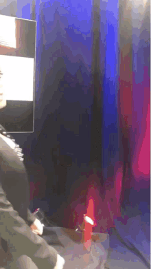 a blurry picture of a person standing in front of a tv