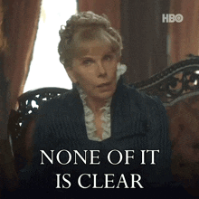 a woman sitting in a chair with the words " none of it is clear " on the bottom