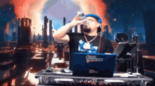 a man drinking from a bottle while sitting in front of a laptop with the word racer written on it