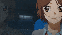 a girl with brown hair is sitting in a blue seat