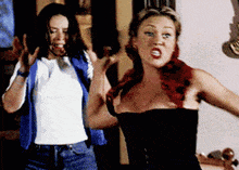 two women are standing next to each other and one of them is wearing a corset