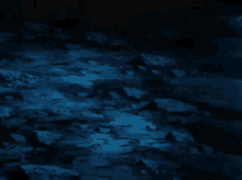 a cartoon character is holding a sword and fighting another character in a cave .