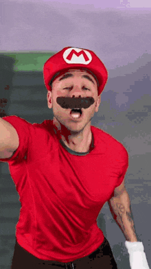 a man dressed as mario with a red shirt and hat