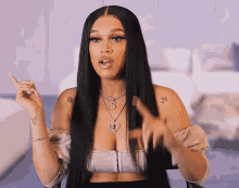 a woman with long black hair has a tattoo on her arm that says 3