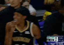 a washington basketball player wears a headband with car max on it