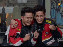 two young men are posing for a picture with one wearing a jacket that says racing