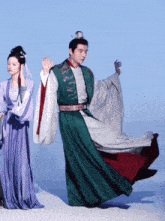 a man in a green and white outfit is dancing with a woman in a purple dress