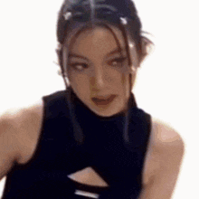 a close up of a woman wearing a black tank top with a cut out in the middle .