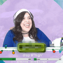 a woman is smiling in front of a sign that says drop a high