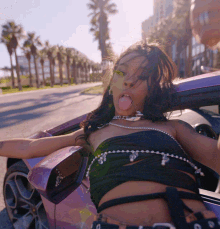 a woman is sticking her tongue out while sitting in a car