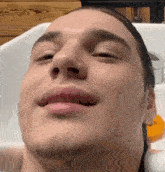 a close up of a man 's face with his eyes closed in a sink .