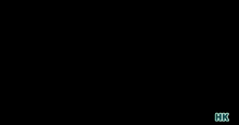 a man in a red shirt is walking through a doorway with hk written on the bottom