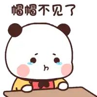 a panda bear is sitting at a table with a tear running down its face .