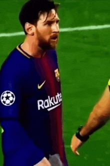 a soccer player wearing a jersey that says rakute is shaking hands with another player on the field .