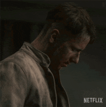 a man with blood on his face and a netflix logo in the corner