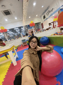 a woman taking a selfie in front of a shop