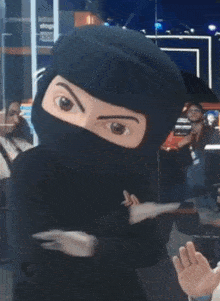 a ninja mascot is wearing a black helmet and mask