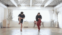 a man and a woman are dancing in a room with white walls