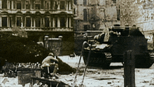 a black and white photo of soldiers and a tank with the number 7777 on the side