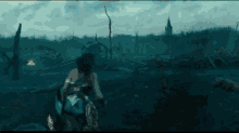 a woman is running through a field with a sword in her hand .