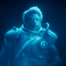 a man in a space suit with the words what you hear behind him