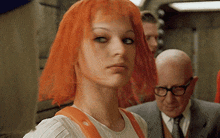 a close up of a woman with orange hair and glasses