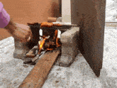 a person cooking food on a grill made out of bricks